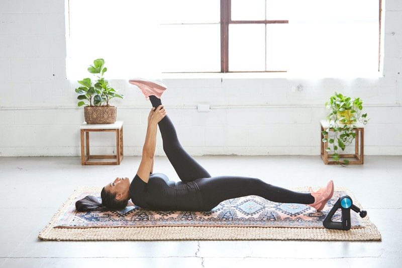 Mujer haciendo poses de yoga en la sala de una casa